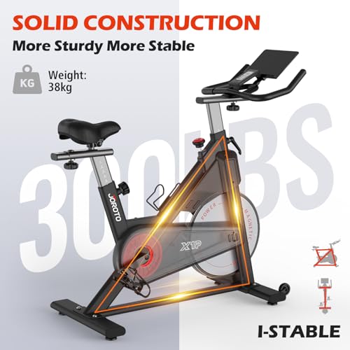 JOROTO Bicicleta Estática Magnética, bici estatica para en Casa con transmisión por correa, manillar ajustable en 4 direcciones, monitor LCD, soporte para tableta extra grande, capacidad de 150 kg.